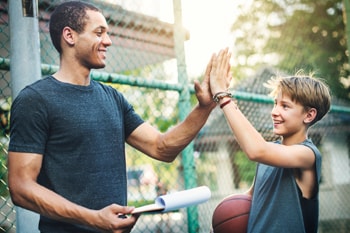 Coach high-fiving a child