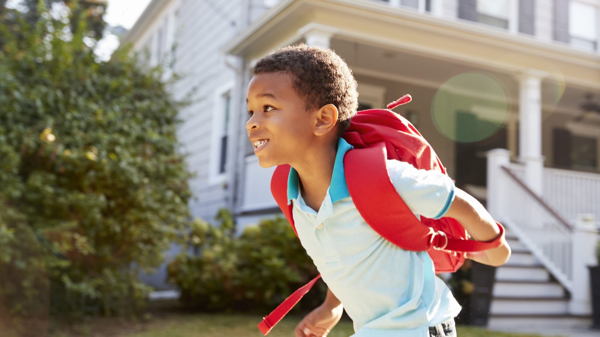 Boy running with backpack on