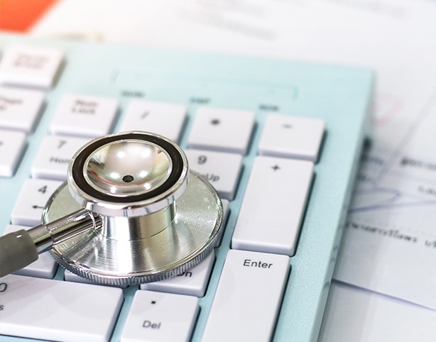 closeup of a stethoscope on a computer keyboard