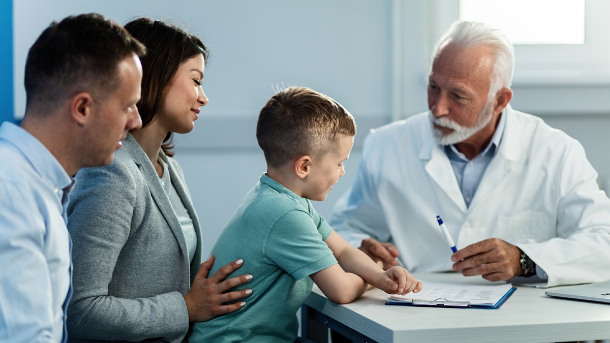 A doctor meeting with parents and their son