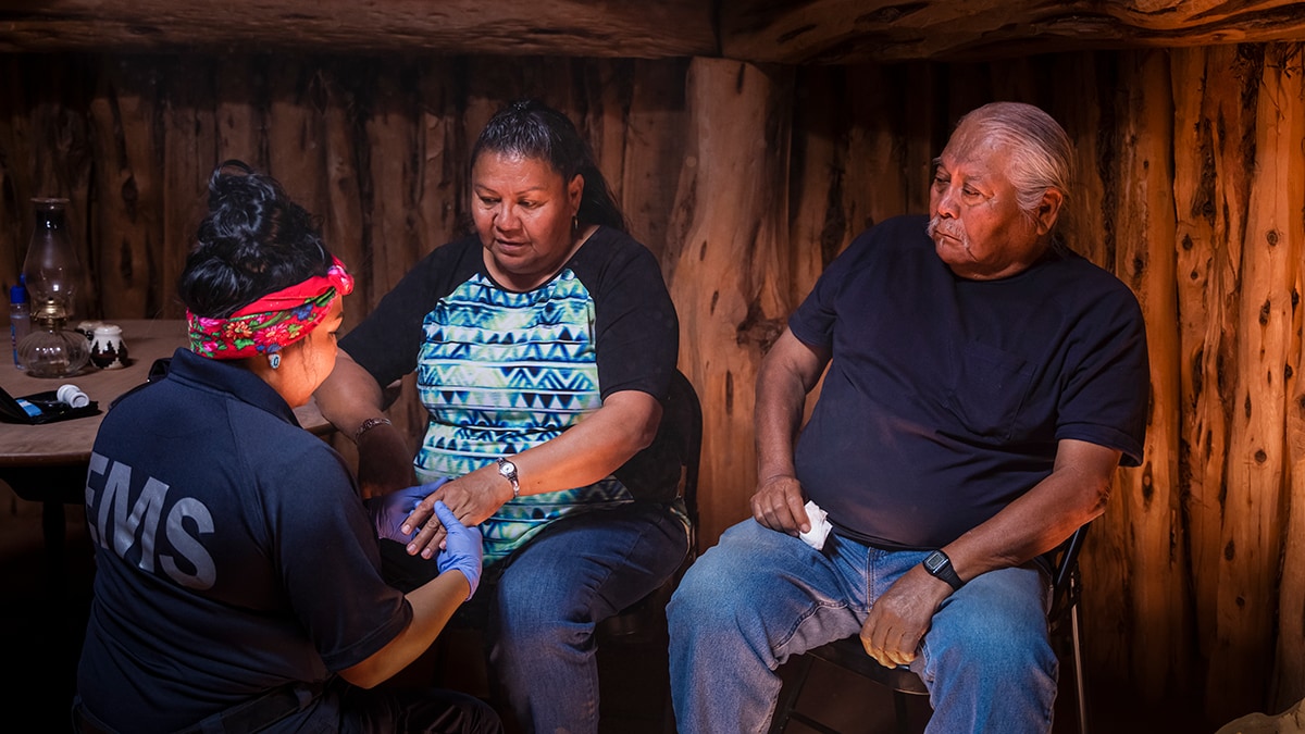 Native man and woman being treated by EMS