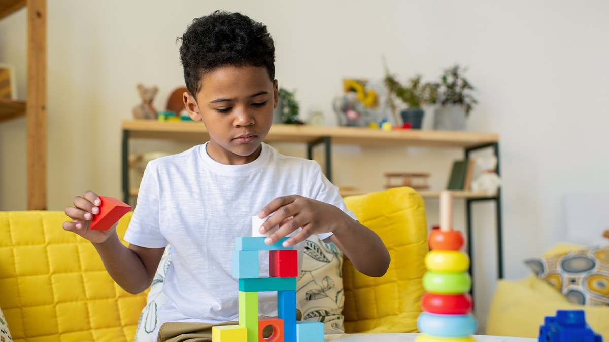 Young child playing with colorful blocks