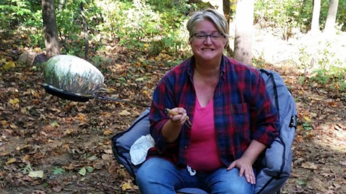 Heidi sitting on a chair in a forest