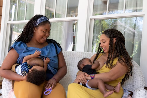 Two moms breastfeeding their babies.