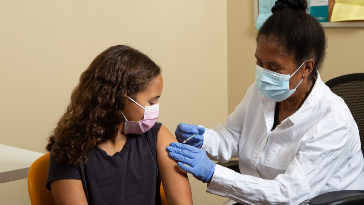 a doctor giving an HPV vaccine to a girl