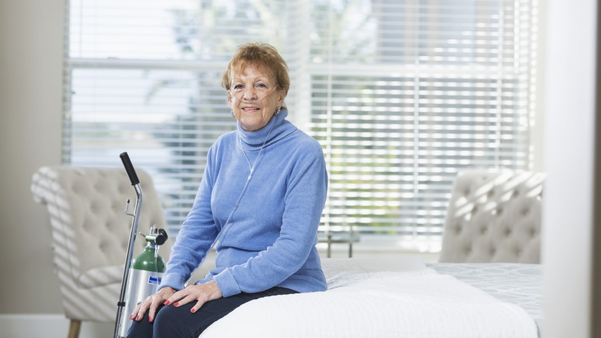 Photo of a woman with a portable oxygen tank