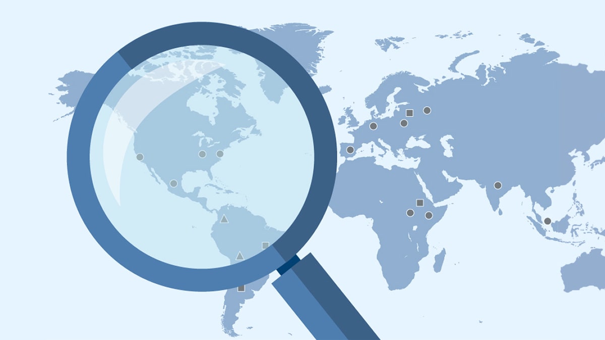 Illustration of a magnifying glass placed over a map of the world