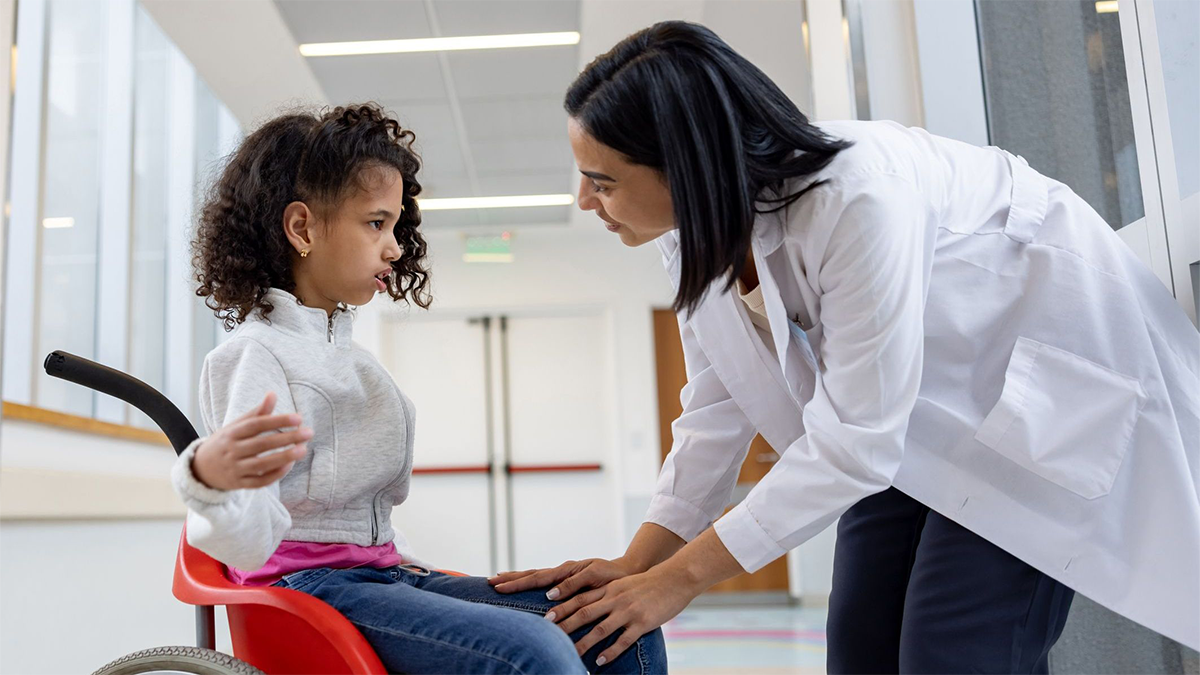 Child with CP in chair speaking with doctor