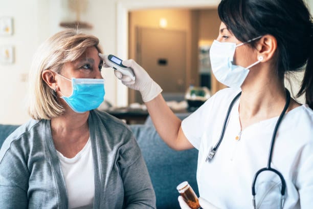 Health care provider taking a patient's temperature.