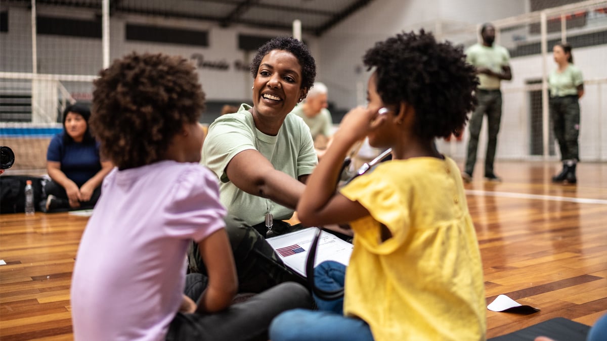 Community worker playing with kids at a community center