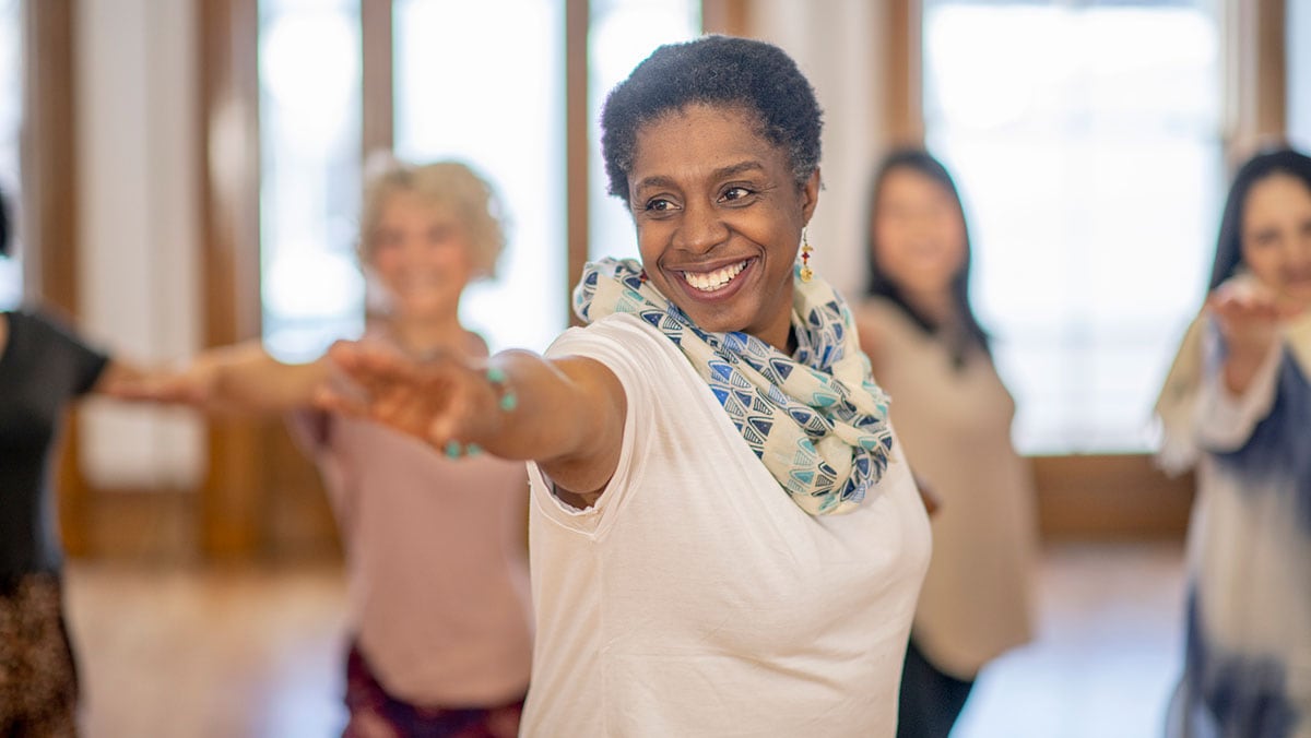 smiling woman doing yoga