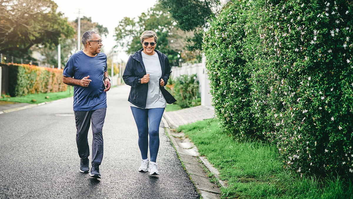 Full length shot of a senior couple bonding together while running outdoors