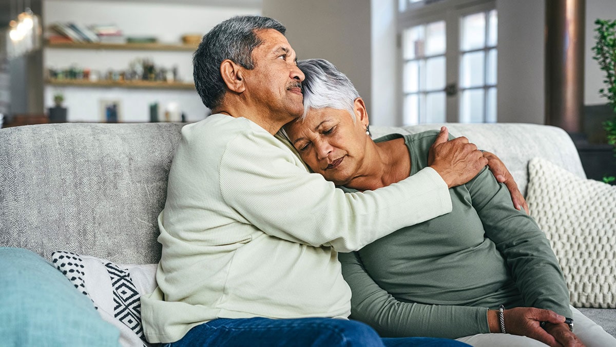 senior man supporting his wife during a difficult time at home