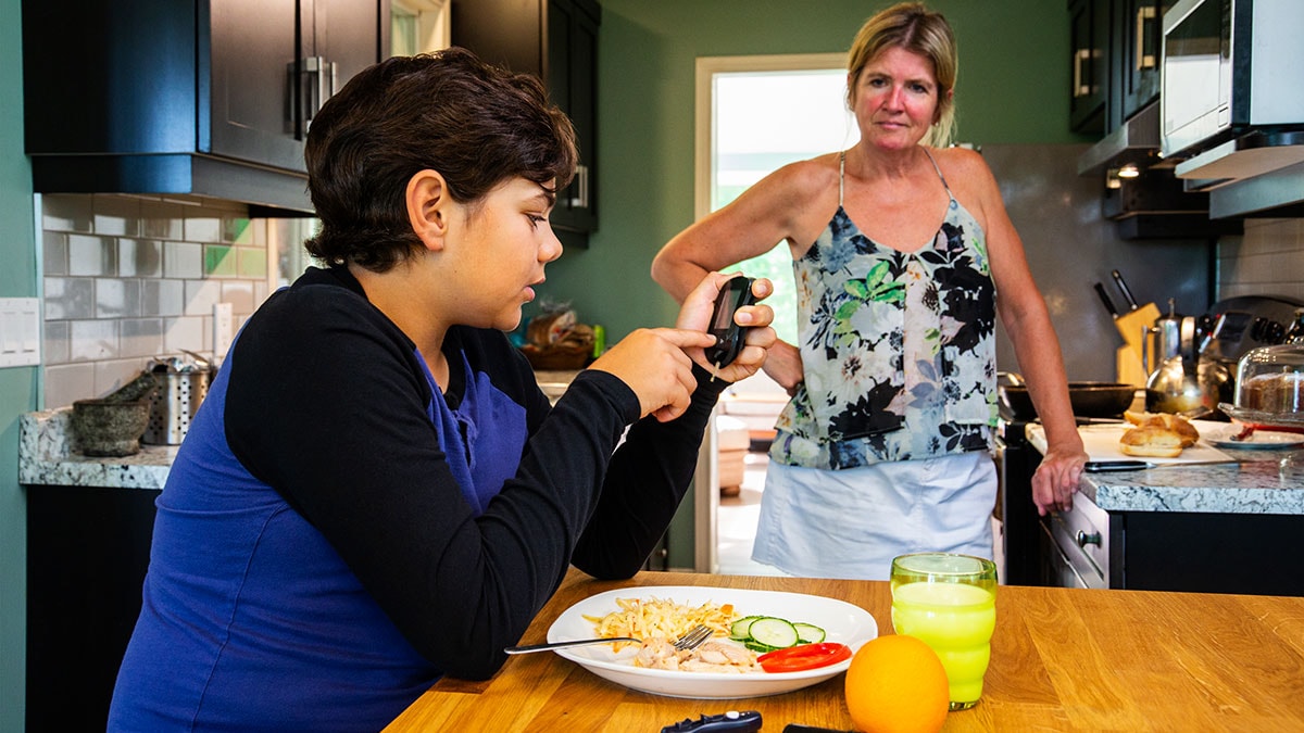 young diabetic patient at home testing his blood sugar