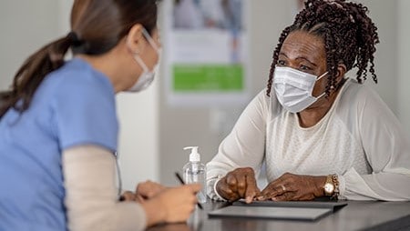 Patient talking to health care provider.