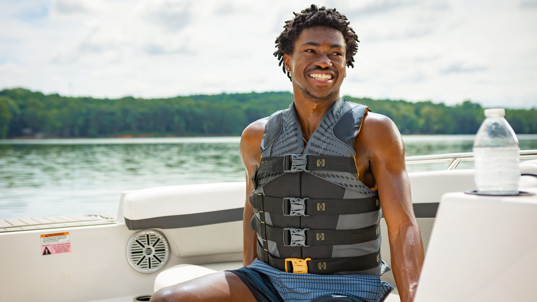 Young man on boat wearing a life jacket.