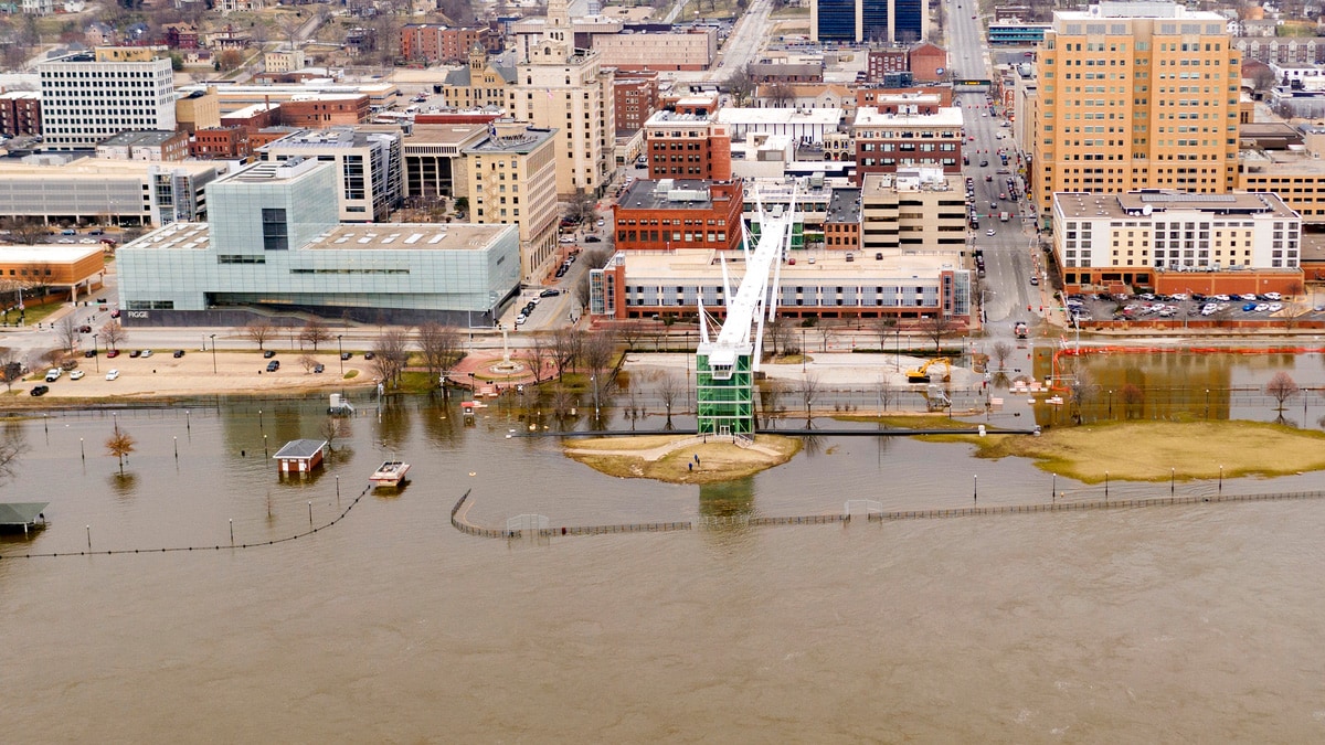 Aerial view of muddy flood waters encroaching city streets