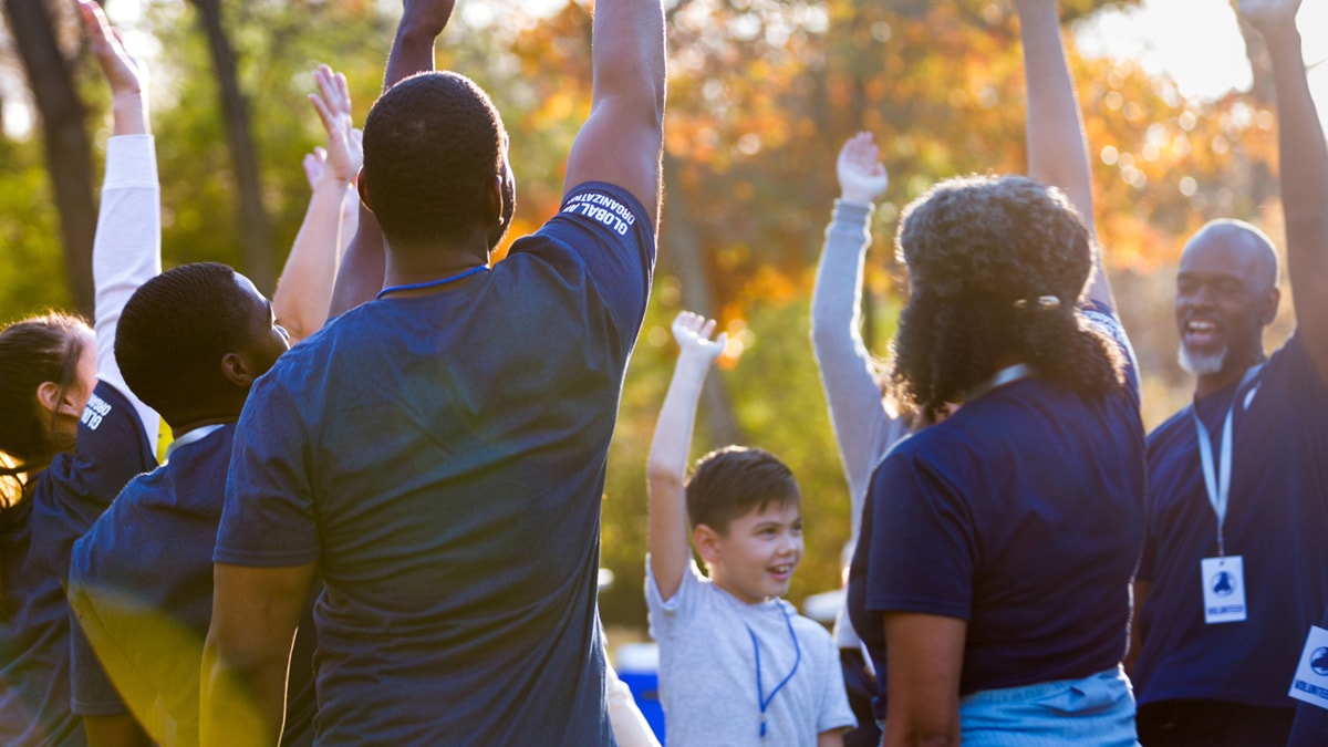 Group of people raising arms in unison