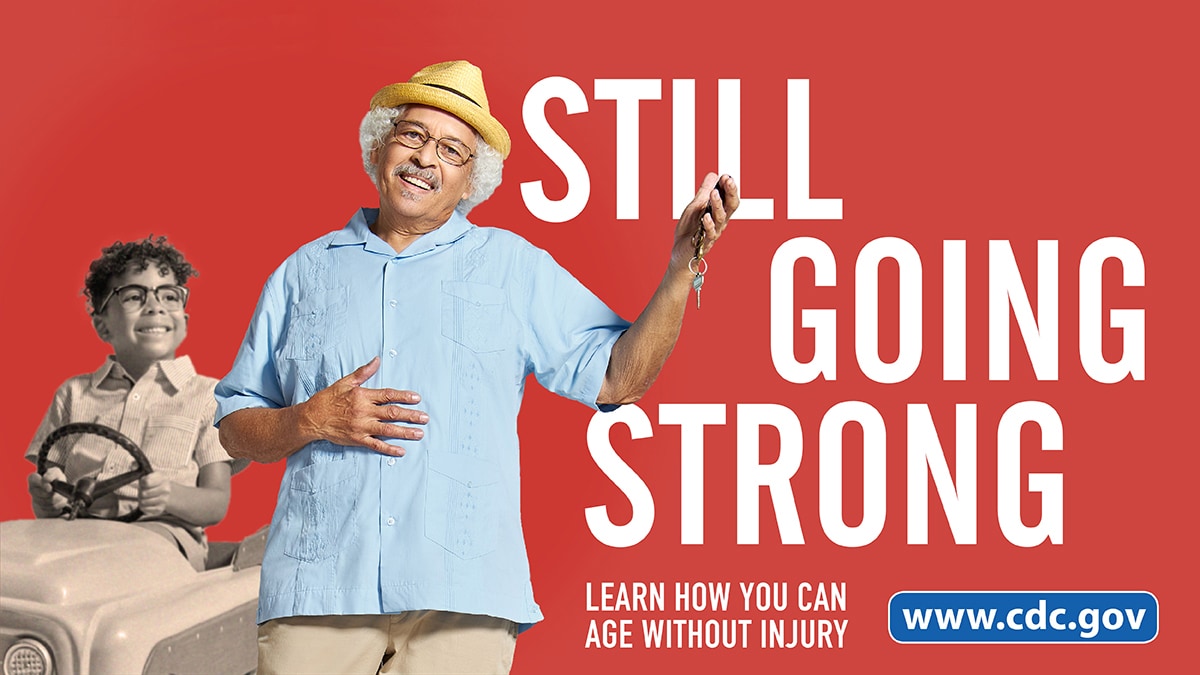 Older man smiling and holding keys in foreground with younger self driving in the background. Still Going Strong. Learn how you can age without injury.