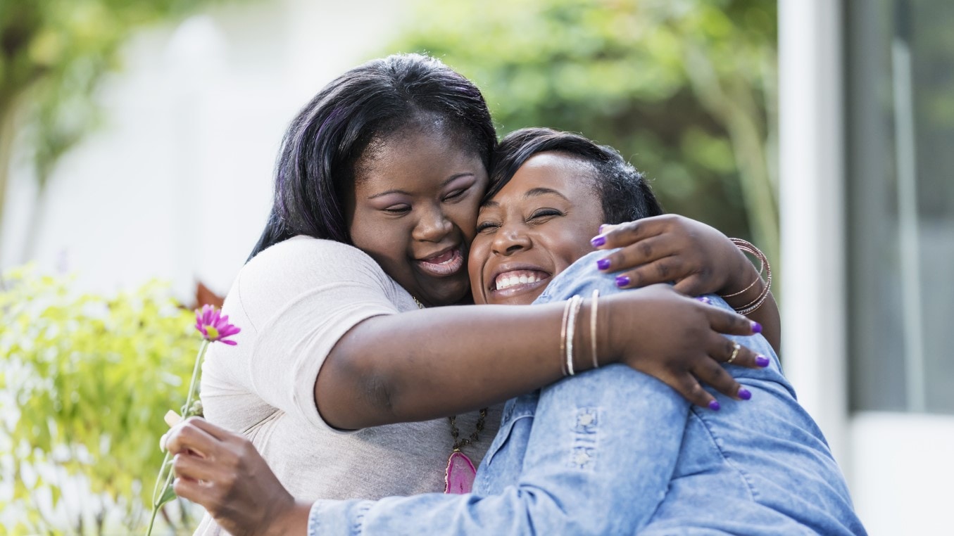 Mother and daughter hugging.