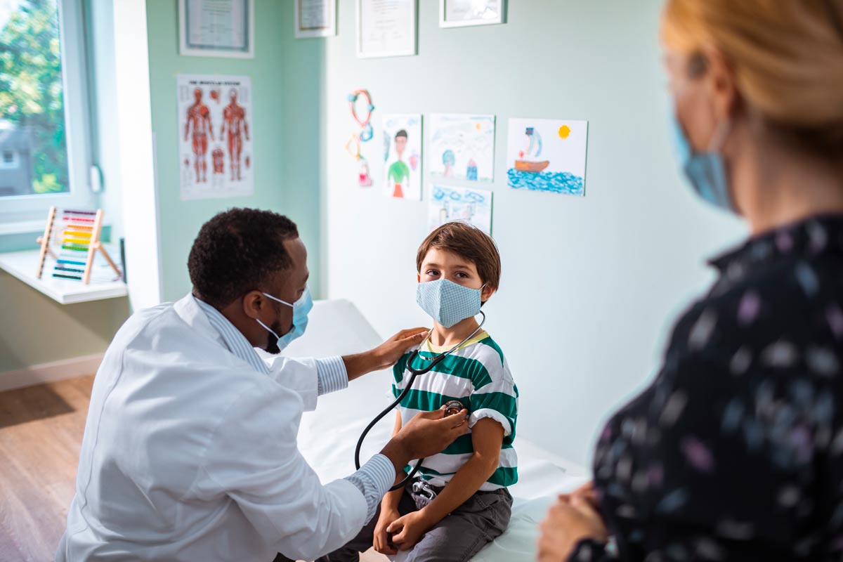 Child having a checkup with mask on