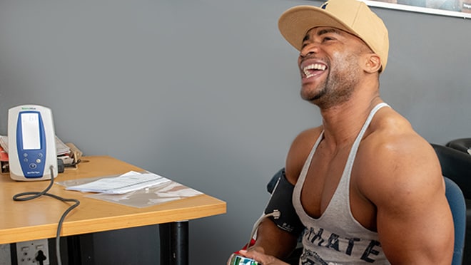 A man at VMMC clinic smiles at the camera.