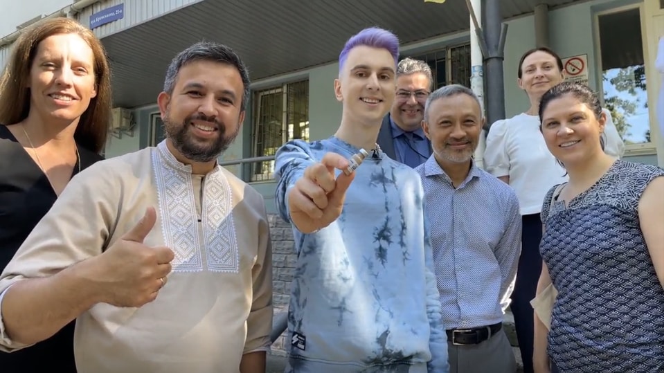 CDC employees stand with the first recipient of CAB-LA.