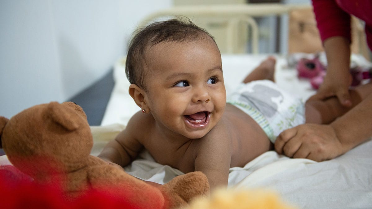 A health worker performs an exam on an infant.