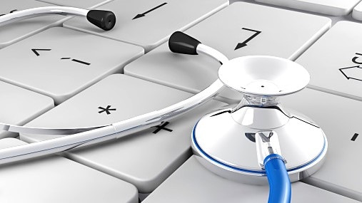 A stethoscope sitting on a keyboard