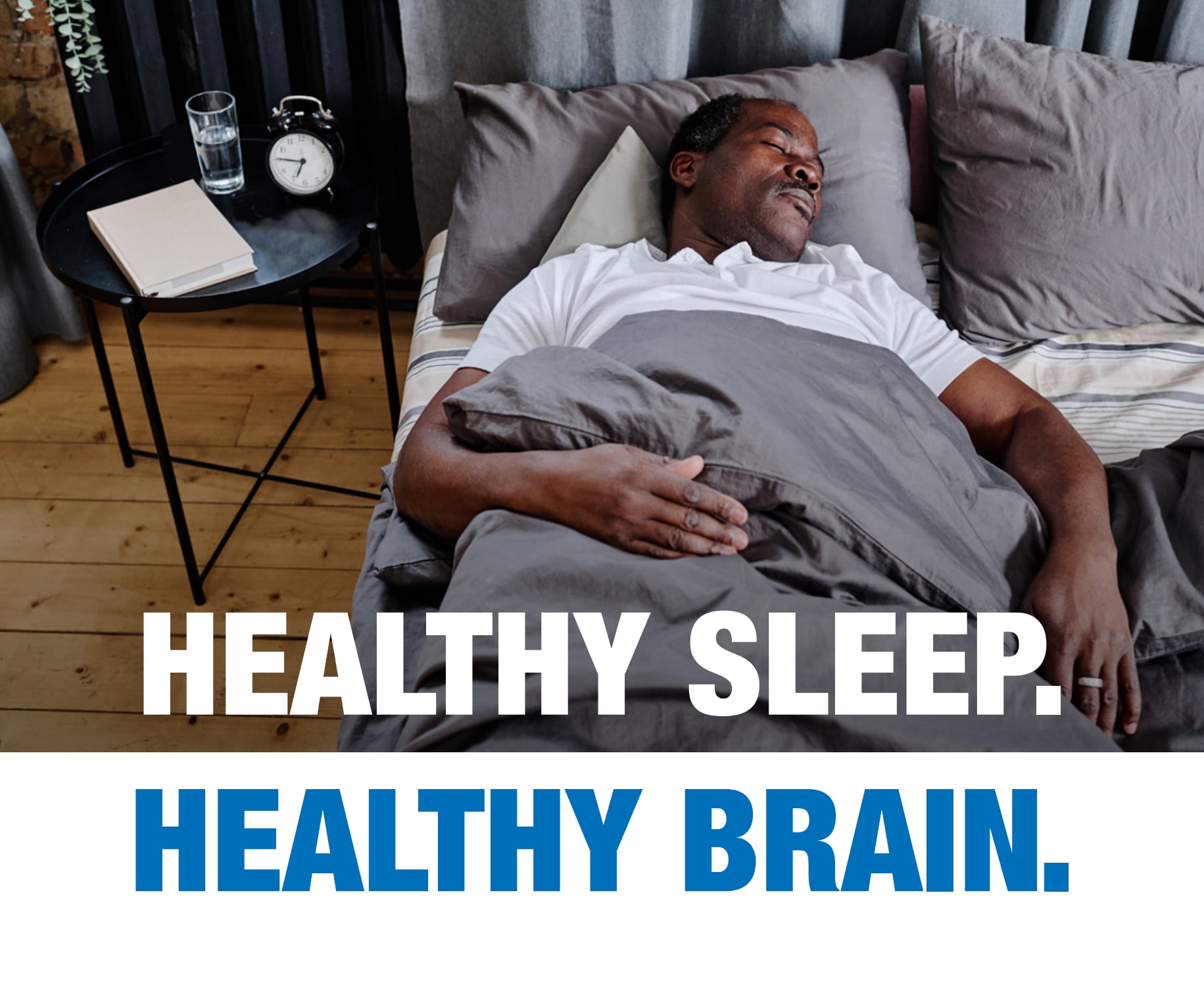 African-American man sleeping peacefully in bed. Text: Healthy Sleep. Healthy Brain.