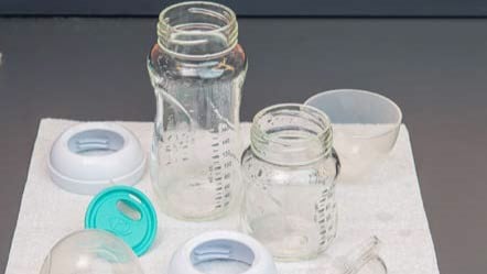 Infant feeding items air drying on an unused paper towel.