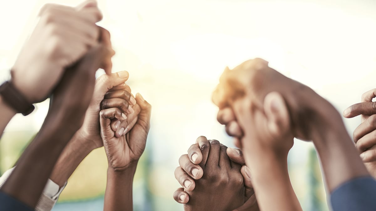 Group of people holding hands.