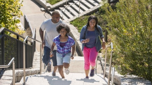 Family walking up stairs together.