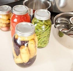 Canned goods near pans on stove