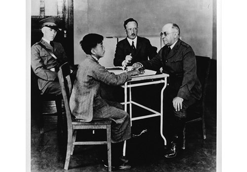 National Library of Medicine; photograph by P.E. Brooks - U.S. Public Health Service (PHS) and Immigration Service officers interrogating a Chinese immigrant, Angel Island, California, 1923 - Asian immigrants who arrived the first part of the 20th century received special scrutiny because they were considered disease carriers. The Asian community mounted many legal challenges to these practices.