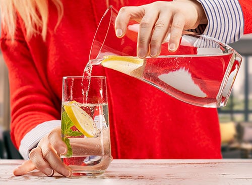 A pitcher of water with lemon