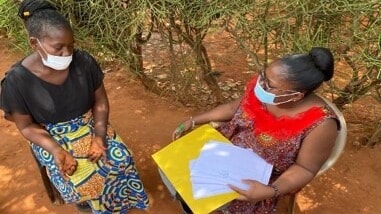 A community health workers administers a KAP guide