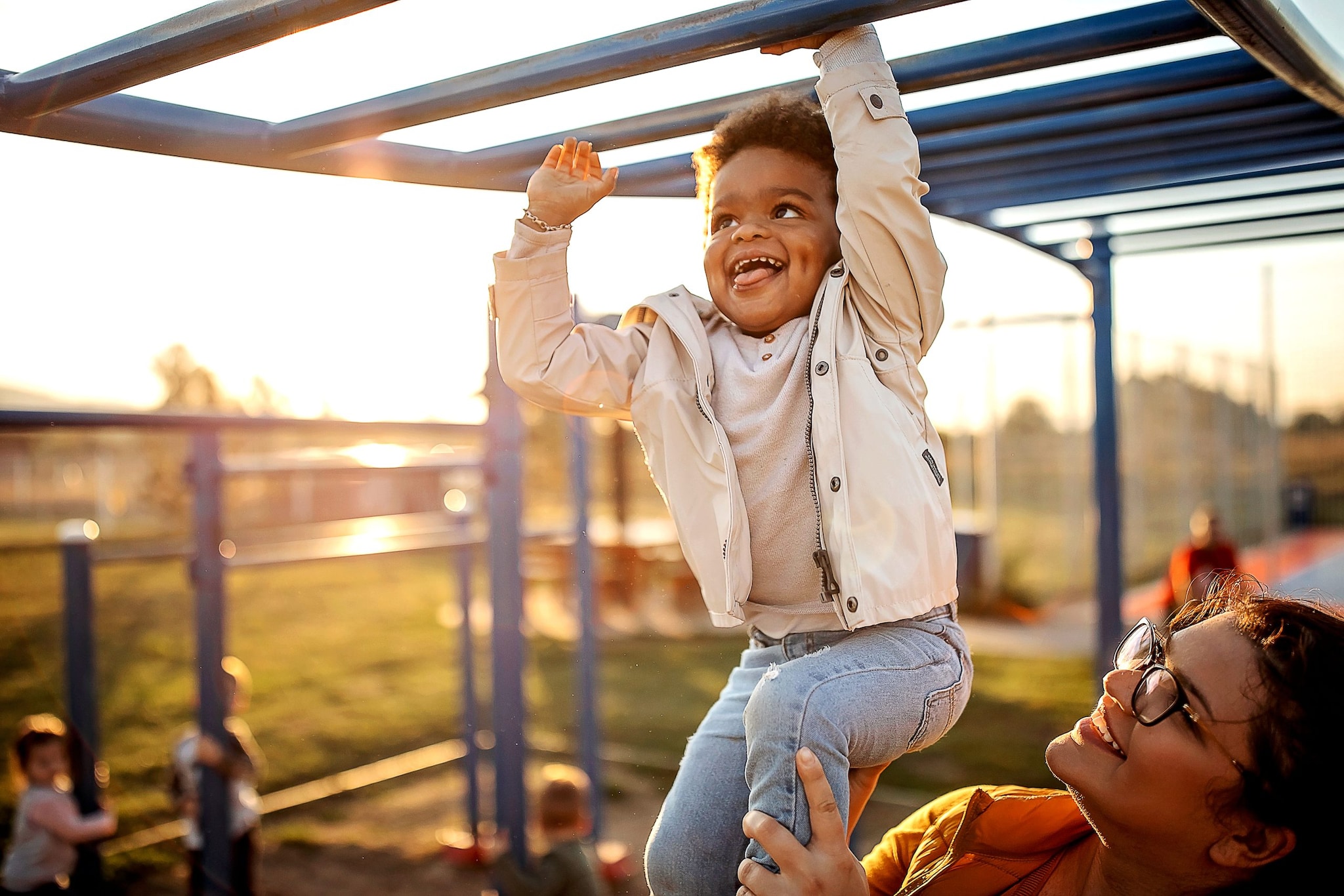 Decorative: Happy child plays on playground with mom