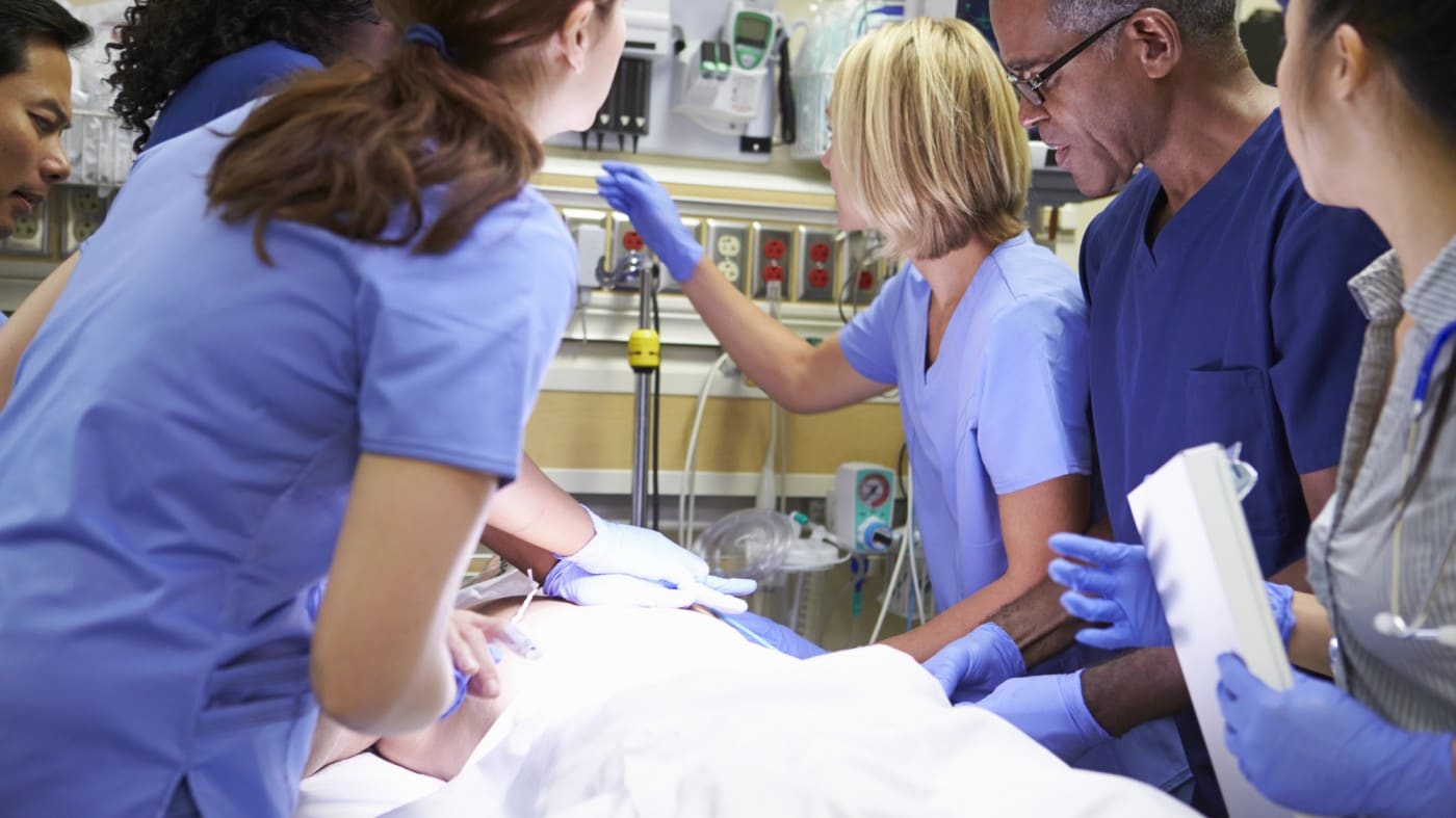 Emergency department staff work on a patient on a stretcher