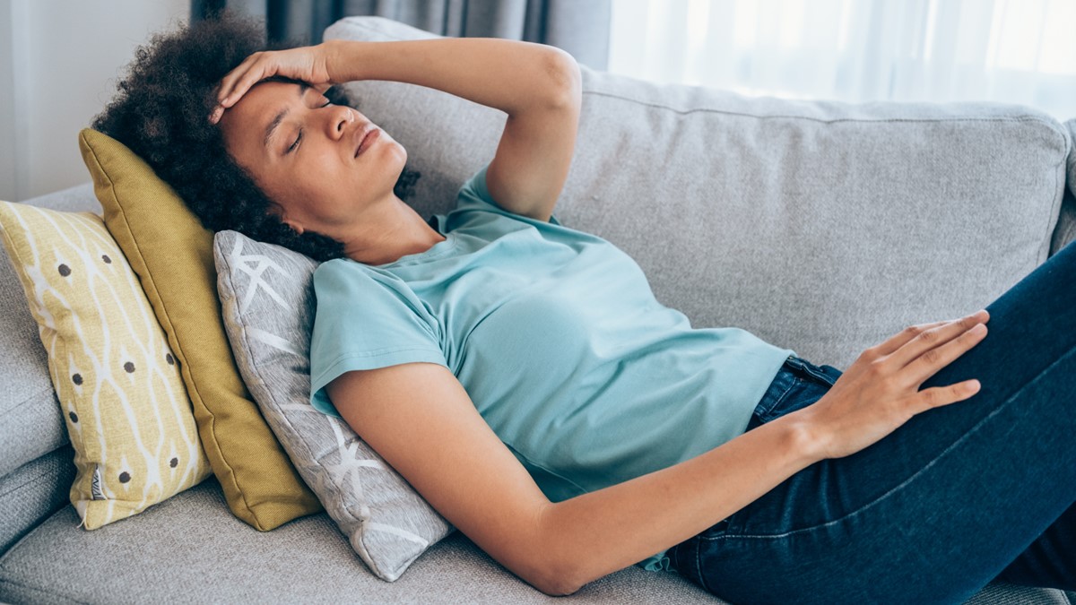 Photo of a sick person who has a headache and is resting.