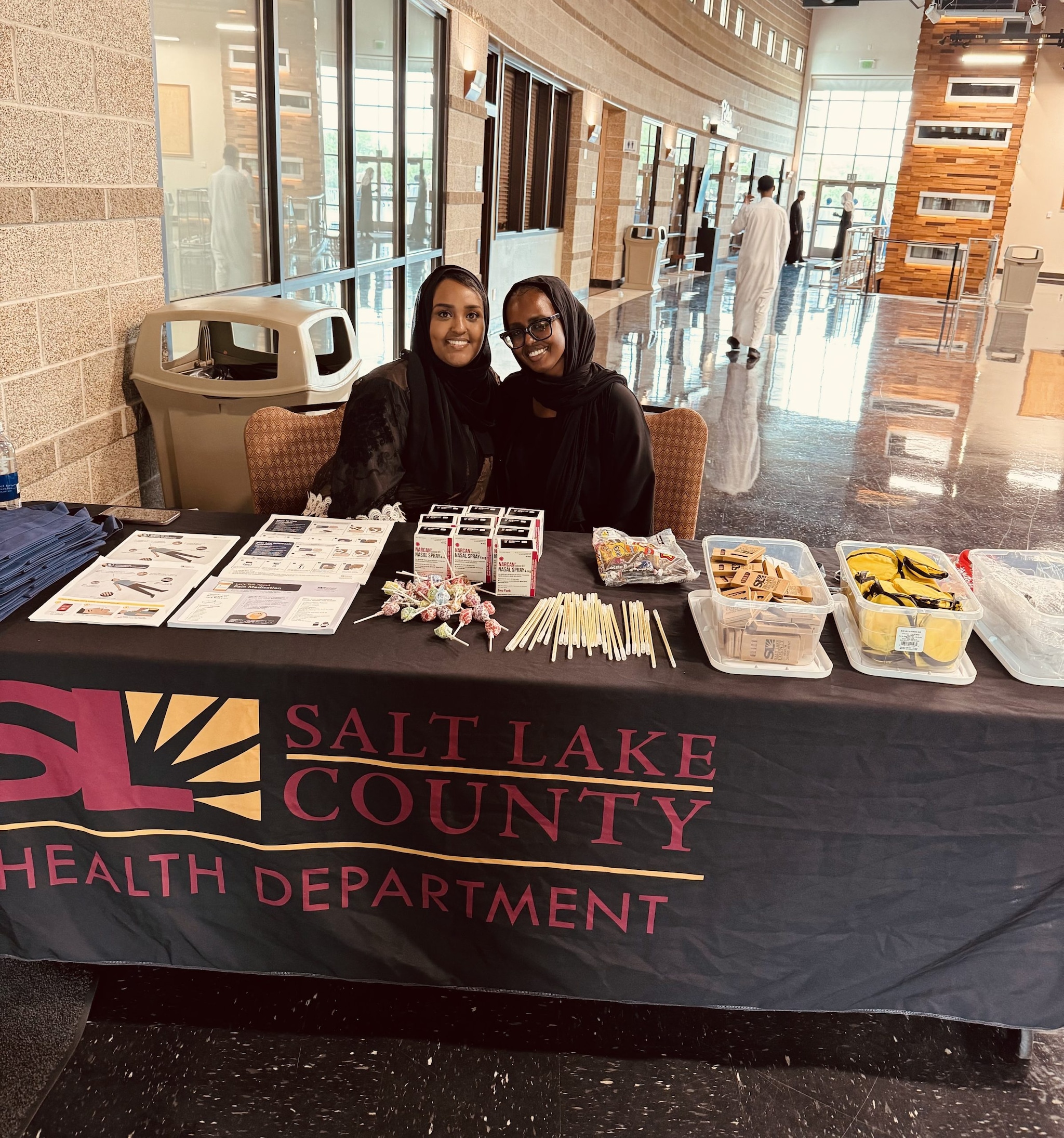 Ayan (left) and Halima (right) tabling at a graduation event for Somali residents completing their Koran study courses.