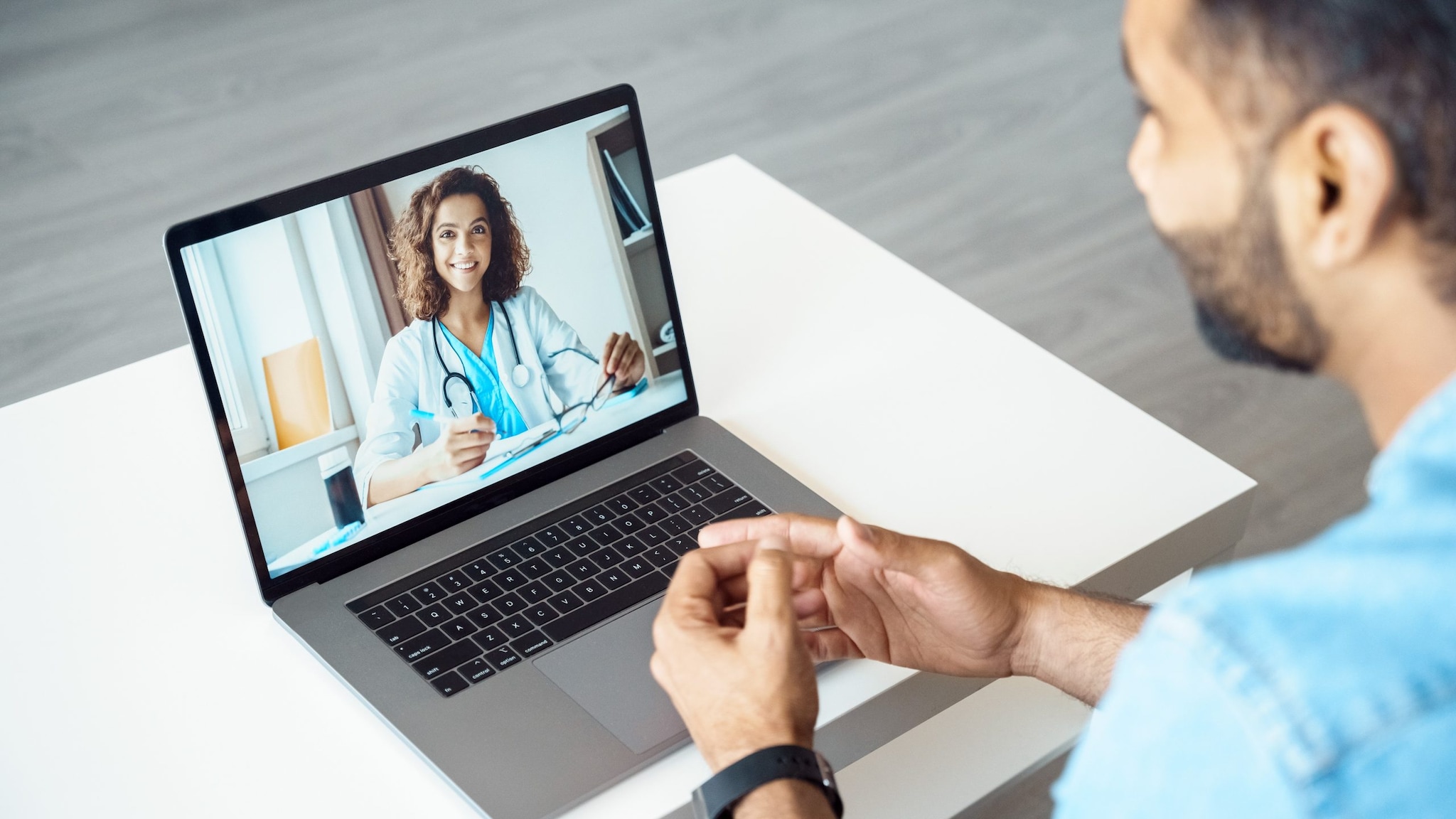 A man on a telehealth appointment with his doctor.