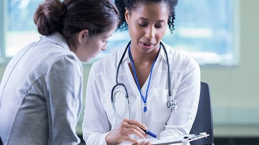 A clinician consults with a female patient.