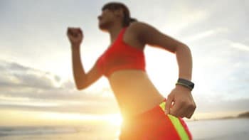 Woman wearing a smart watch exercising.