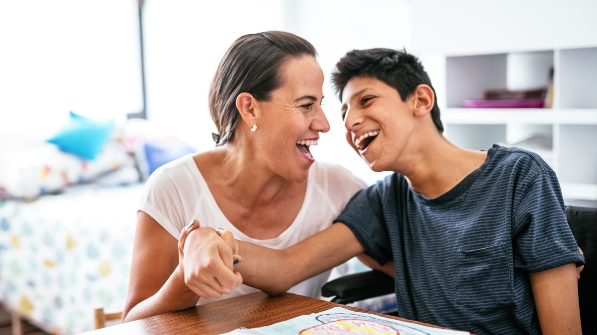 Woman sharing a laugh with a person with disability