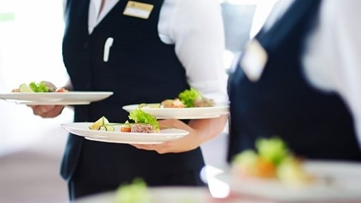 Servers holding plates.