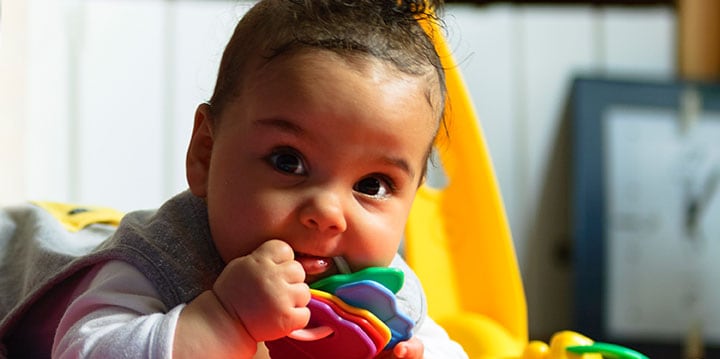 baby chewing on toy