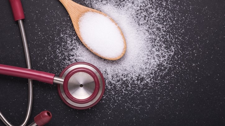 Photo illustration of a wooden spoon with salt and a stethoscope.