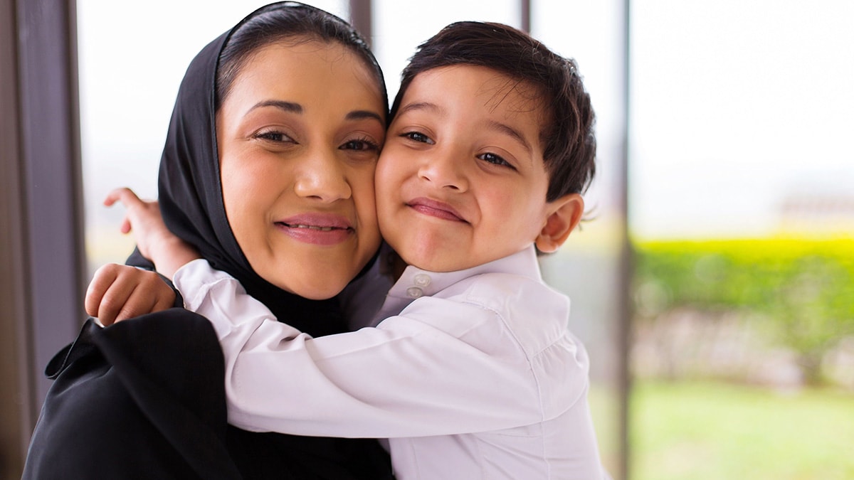 Boy hugging his mother.