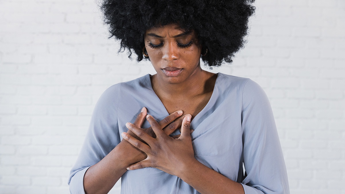 A woman holding her chest.